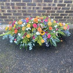 Casket Spray of Bright Coloured Flowers