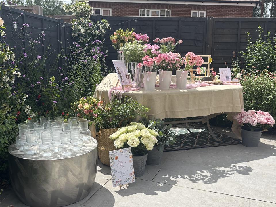 Complete private Bloom Bar party setup with fresh flowers and glass vases