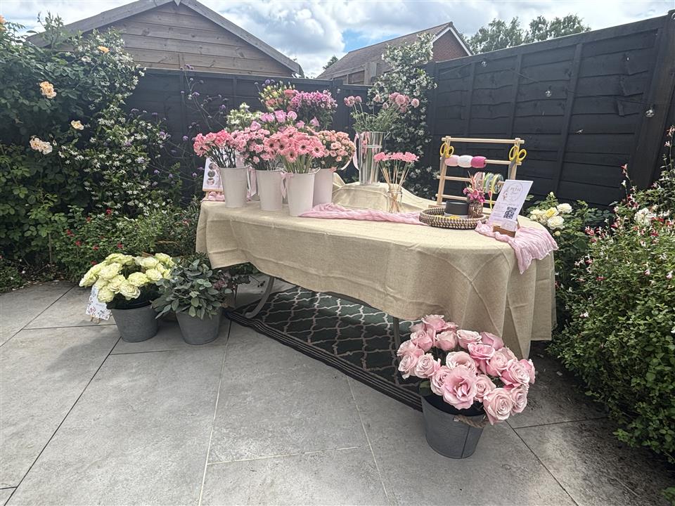 Guests holding their finished flower arrangements at a private Bloom Bar party